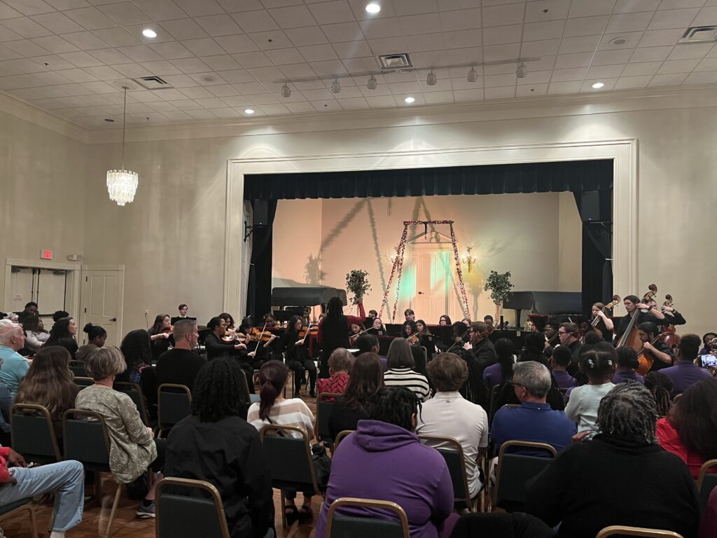 audience watching orchestra with empty stage
